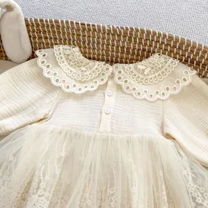 Detail of baby girl cream lace romper with floral embroidery and ribbed knit texture