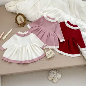 Detail of three knitted girls' dresses featuring ruffled collars and vertical rib textures