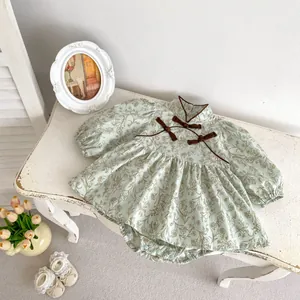Detail of baby floral bodysuit featuring traditional Chinese frog buttons and stand collar