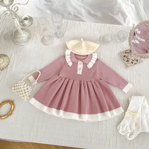 Flat lay detail of girl's knit dress with ruffled collar and matching accessories