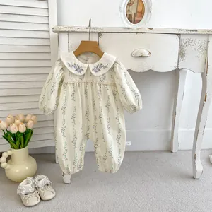 Detail of baby floral romper with Peter Pan collar and delicate purple embroidery
