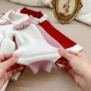 Close-up of girls knitted dress showing elastic ribbed cuffs and delicate ruffled collar