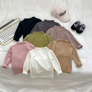 Flat lay of colorful thermal kids' long sleeve tees in various warm autumn shades