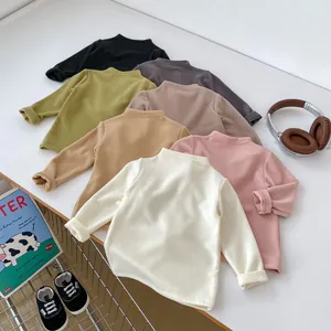 Flat lay of soft knit long sleeve thermal shirts for toddlers in six neutral colors