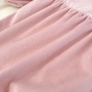 Baby girl pink corduroy romper with cute bunny ears detail and ruffled waist texture
