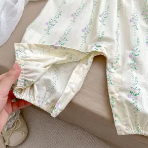 Detail view of cotton floral baby romper featuring resin snaps and soft elastic cuffs