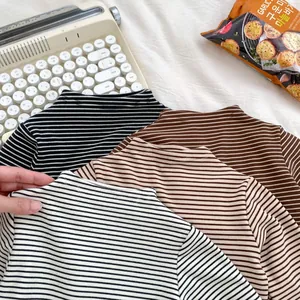 Detailed flat lay of toddler striped high-neck t-shirts in black, coffee, and khaki colors