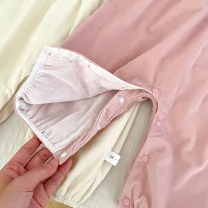 Detail of snap button crotch on a soft ribbed infant romper for easy diaper changes