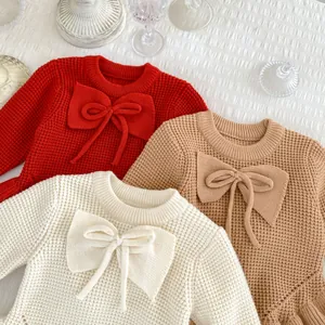 Jersey de punto para niña con lazo grande y dobladillo con volantes en beige