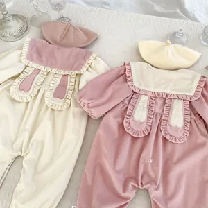 Detail of baby rompers with cute rabbit ears collar and matching beret in soft corduroy