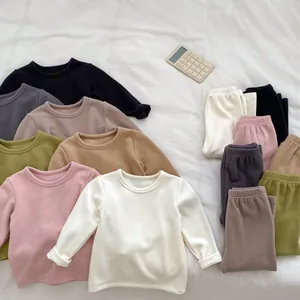Flat lay of soft thermal kids loungewear set featuring long sleeve top and elastic pants