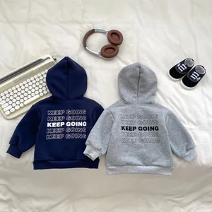 Detailed back view of fleece-lined hoodies with Keep Going text and ribbed cuffs