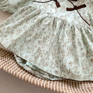 Detailed view of floral baby romper with Chinese style butterfly knot and snap closure