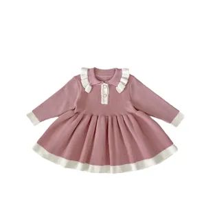 Pink knit long sleeve girls dress with white contrasting collar and pleated skirt