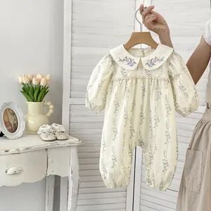 Detail of Peter Pan collar with delicate purple floral embroidery on baby floral romper