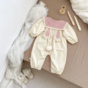 Detail of baby bunny romper showing pink rabbit ears on back and plush tail