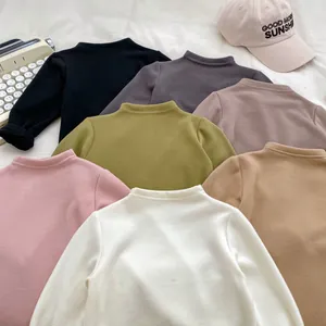 Detailed close-up of multi-color thermal turtleneck base shirts for babies and toddlers