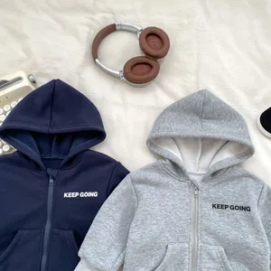 Detail of zip-up hoodies with KEEP GOING print and fleece lining for toddler boys