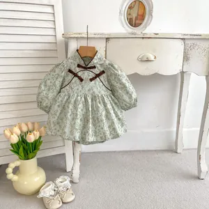 Detail of floral baby bodysuit with traditional Chinese buttons and lace shoes