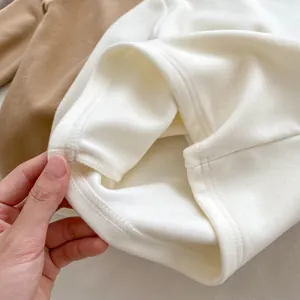 Detail of neat double-needle stitching and soft thermal fabric on baby base layer