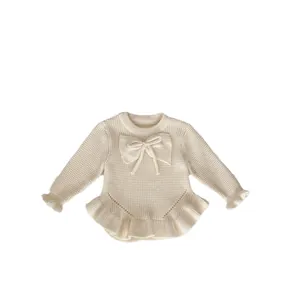 Jersey de punto blanco crema para niña con lazo y dobladillos con volantes