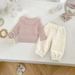 Pink ruffled long sleeve top and beige corduroy pants with lace trim two-piece outfit