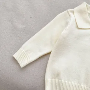 Close-up of fine knit ribbed cuffs and collar on baby cream sweater for toddlers