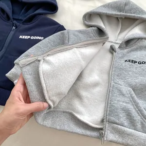 Detail of fleece lining in navy blue and heather grey zip-up hoodies for toddler boys