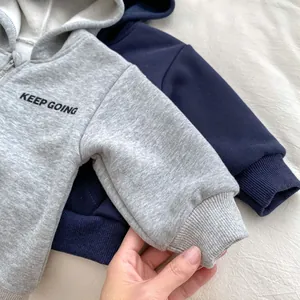 Detail of ribbed cuffs and soft fleece lining on kids hooded zip-up sweatshirts
