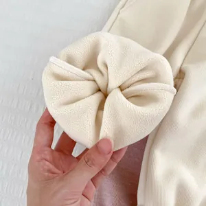 Fleece lined girls trousers in beige with thick insulation and ribbed texture for winter