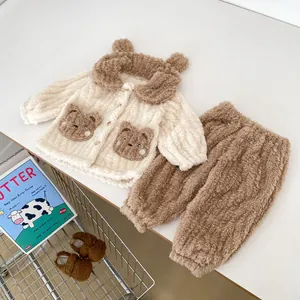 Detailed view of plush cream teddy fleece jacket and brown trousers infant pajama set