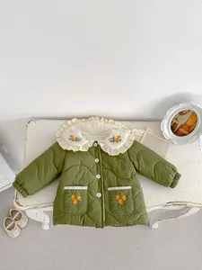 Detail of baby girl green quilted jacket with floral embroidery and white ruffle collar