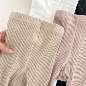 Détail de leggings en coton côtelé montrant l'élasticité et la texture en plusieurs couleurs