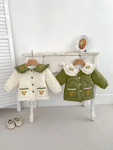 Detail of floral embroidery on vintage style quilted cotton jacket for girls
