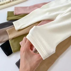 Close-up of stretchy kids thermal leggings in multiple colors with reinforced hem detail