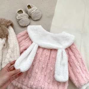 Detail of plush baby winter outfit with rabbit ears on thick fleece collar and soft shoes
