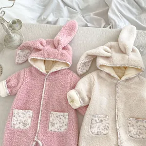 Detailed close-up of fluffy baby rompers with cute bunny ears and floral lining