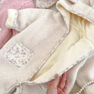 Fleece baby romper with floral lining and cute bunny ear hood for winter warmth