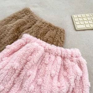 Close-up of pink and brown plush children's thermal pants with cozy elastic waistband
