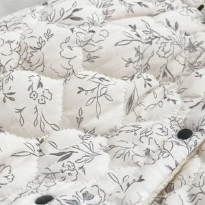 Quilted floral baby winter jumpsuit with diamond stitching and black snap buttons