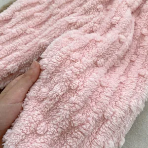 Close-up of soft pink flannel fleece fabric showing thick plush texture for warmth