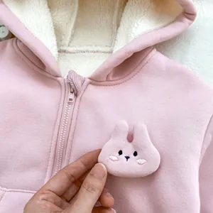 Detail of pink toddler hoodie featuring soft fleece lining and cute rabbit decoration