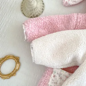 Detail of plush baby romper with floral lining and thick warm sherpa fleece material