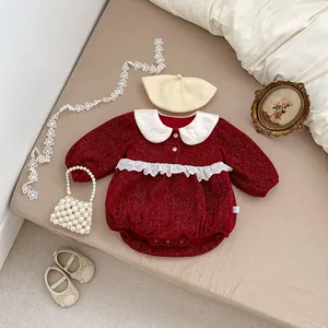 Close-up of baby girl wine red romper featuring lace details and white Peter Pan collar
