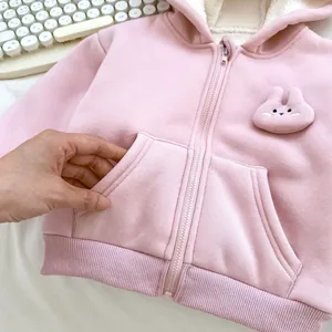 Detail of baby girl pink fleece hooded jacket with cute 3D bunny patch and kangaroo pocket