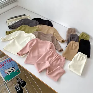 Detailed flat lay of soft children's thermal pajama sets in diverse Morandi colors