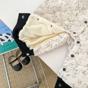 Detail of baby quilted jacket featuring floral pattern and warm sherpa fleece lining