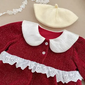 Detail of red glitter knit baby romper with large white collar and lace embroidery
