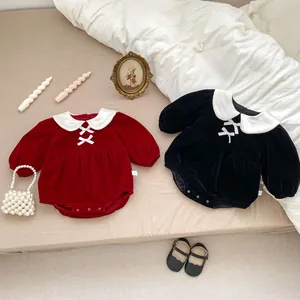 Detail of baby velvet rompers showing Peter Pan collars and soft plush fabric texture