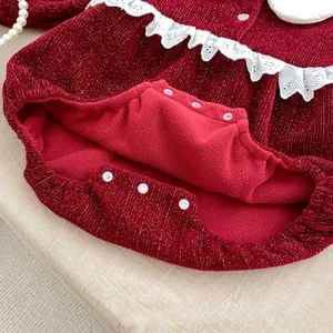 Detail of baby winter romper with lace embroidery and metal snaps for diaper change